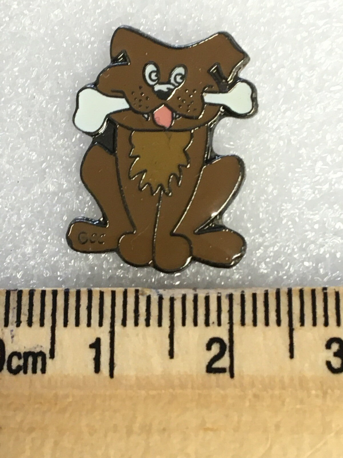 Small brown  dog with a bone pin badge1